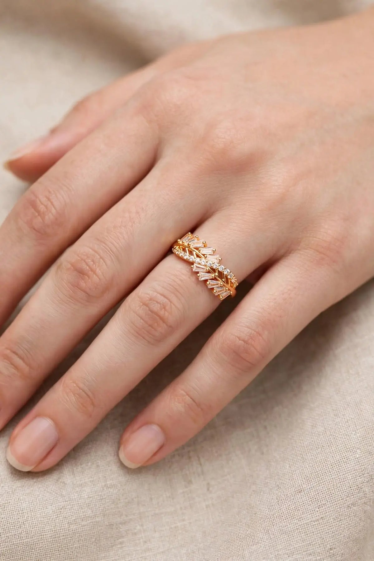 Woman wearing LUVORA Gold Leaf Crystal Ring - gold plated adjustable leaf design with clear zircon stones on finger